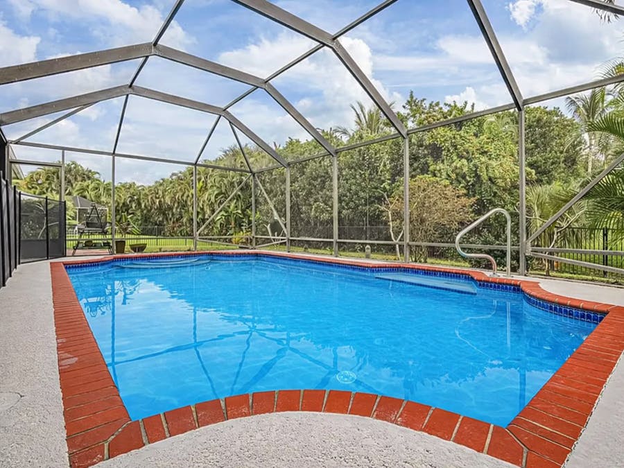 Swimming pool with screened enclosure